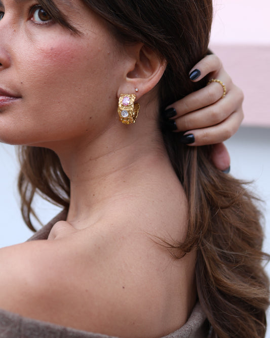 Pair of Crush bold hoop earrings in 18k gold plated 316L stainless steel with pink and white crystal stones.